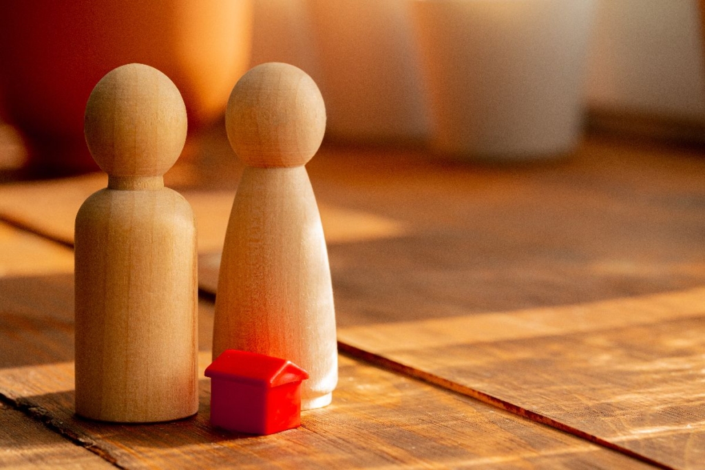 Wooden pegs used to show a couple looking for a dream home