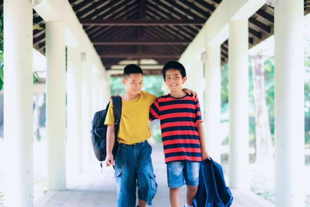 two boys walking through reputable schools in a neighborhood